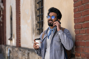 Smiling dark-haired man talking on the phone