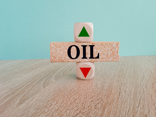 Oil symbol. A wooden cubes with up arrow. Brick block with the concept word OIL . Beautiful blue...