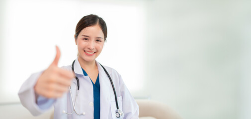 Portrait of Mature Female Doctor Wearing white Coat with Stethoscope Standing in Hospital Corridor. Concept Of Medical Technology and Healthcare Business.