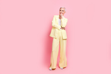 Full length photo of woman grey hair boss choosing strategy invest company money in future development isolated on pink color background