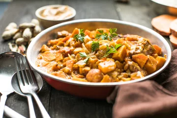 Poster African chicken peanut stew with sweet potatoes  with side of basmati rice © Maria