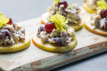 Waldorf salad with copy space. American fruit and nut salad with apples, celery, grapes, chicken meat, dressed mayonnaise.