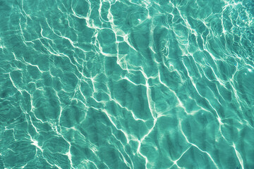 Blue water surface viewed from above in outdoor sea, sun reflection, dimply. Surface Abstract...