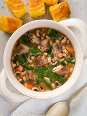 Overhead view of New Year's US Southern traditional black-eyes peas with pork, collard greens, and corn bread
