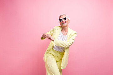 Photo of carefree lady dressed yellow suit with summer style sunglasses clubbing discotheque...