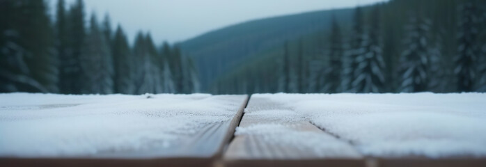 Empty rustic wooden table top on blur background of winter nordic forest. Cloudy moody sky. Abstract snowy counter. Mockup for Eco tourism, hiking ad. Free space for text. Frame for display. Snow dust