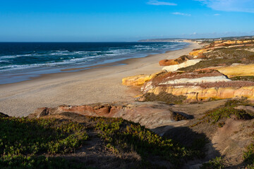 Almagreira beach in the Peniche area with the multicolored sandstone rocks in the Center region of Portugal, at sunset.