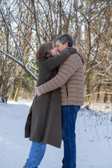 happy couple in winter snowy park