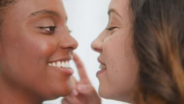 Close up portrait of Black woman and partner in gentle gesture of affection  