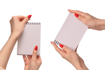 A notebook with empty white paper in woman hands with red nails.