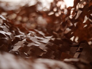Paper filler for parcels. Kraft brown honeycomb packaging paper with slots. Crumpled craft paper...