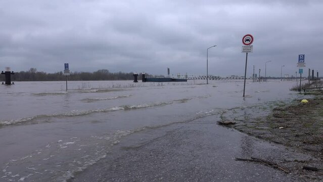 Flooded road and quay in Tolkamer, a small town in the Netherlands that contains an important station that measures the water levels of the Rhine
