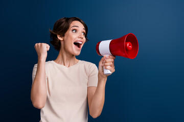 Photo portrait of pretty young girl loudspeaker raise fist celebrate wear trendy white clothes...
