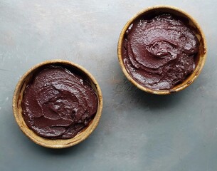 selective focus on two bowls with ice cream and creamy and gray background
