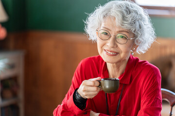 コーヒーを飲む笑顔のシニア女性