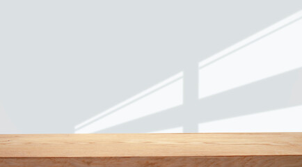 empty table with window shadow on light wall background for product mockup display. kitchen interior theme