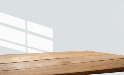 empty table with window shadow on light wall background for product mockup display. kitchen interior theme