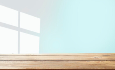 Naklejka premium empty table with window shadow on light wall background for product mockup display. kitchen interior theme