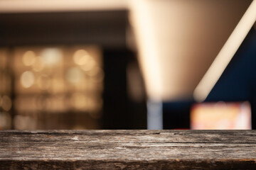 empty wooden table on bokeh background of cafe interior. Empty space to display your products.