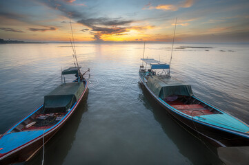 Fototapeta premium traditional long tail boats with sunrise background in southern Thailand