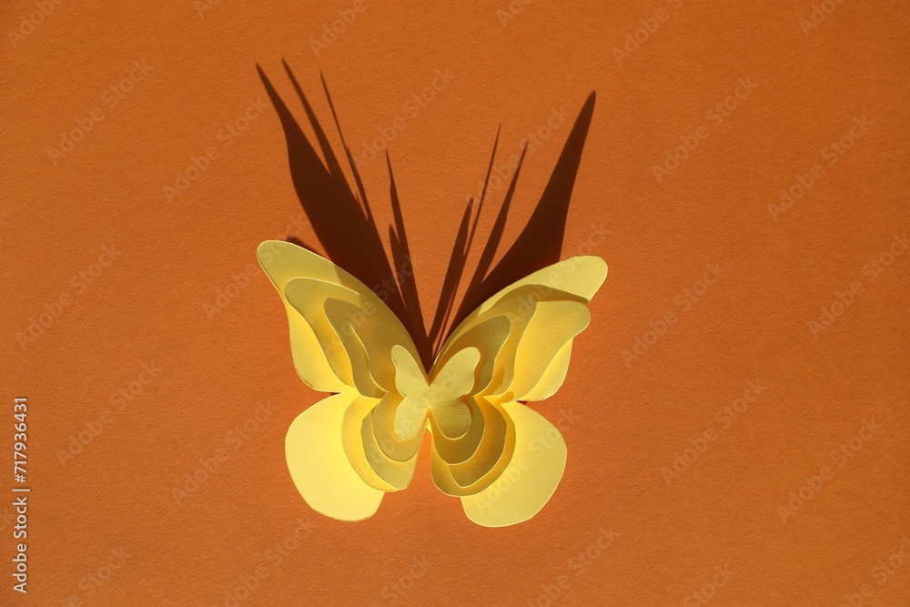 Canvas Prints Yellow paper butterflies on orange background, top view