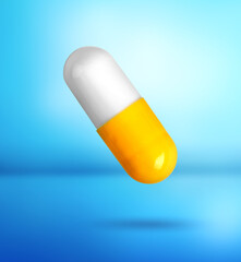 Colorful vitamin capsule in air on light blue gradient background