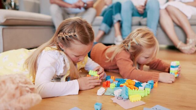 Children, kids and playing with building blocks in living room of home for child development and creative fun. Family, girls and sisters with toys on floor for games, learning and bonding in lounge