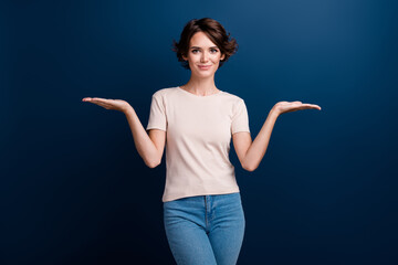 Photo portrait of pretty young girl palm compare hold empty space wear trendy white outfit isolated...