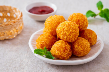 Deep fried cheese balls on plate and ketchup