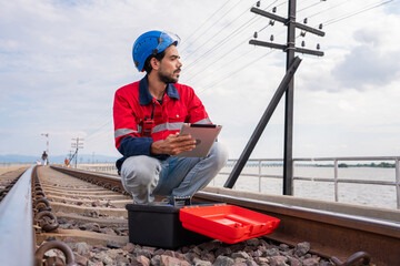 Engineer wearing safety uniform sitting on railway inspection. construction worker on railways. Engineer work on Railway. Rail, engineer, Infrastructure.