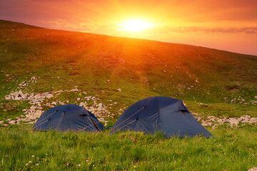 tourist tents in mountains - 717954043