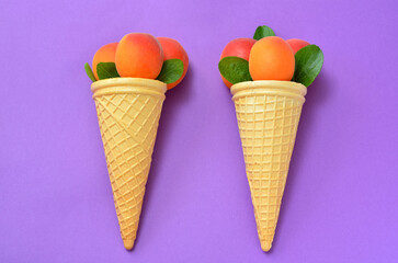 appetizing apricots in waffle cones on a lilac background organic food concept