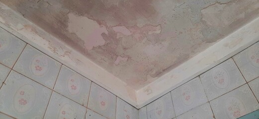 Bathroom ceiling with mold before renovation low angle shot