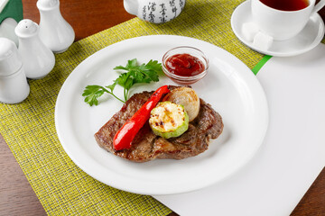 Grilled pork steak with vegetables. Lunch.