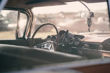 Zelfklevend Fotobehang Vintage car interior with steering wheel and dashboard. Retro car background © WeźTylkoSpójrz