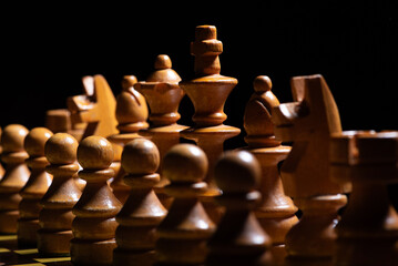 Chess pieces,beautiful old chess pieces on a board, black background, selective focus.