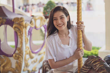Close up face beauty woman smiling with perfect smile and white teeth at Carousel in amusement park...