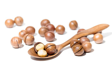 Macadamia Nuts in Wooden Spoon Isolated on White Background