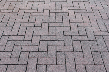 Texture of square cobblestone. Pattern of sidewalk tiles in the street.