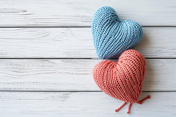 Postcard featuring a blue and red crocheted heart on a wooden white background with space for text.