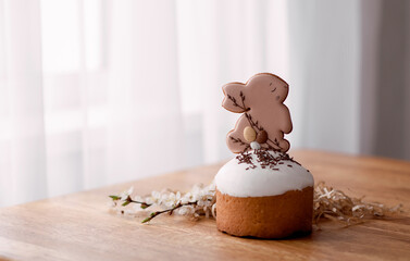 Traditional Easter cake with white Swiss meringue and gingerbread birds. Spring cherry blossom