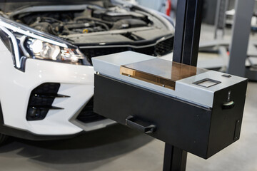 A device for adjusting headlights on a car in a repair shop.