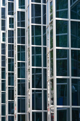 Detail of the glass window grid on a building with reflections - architectural abstraction