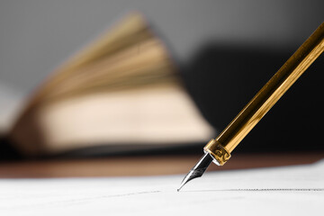 Writing on document with fountain pen at table, closeup and space for text. Notary contract