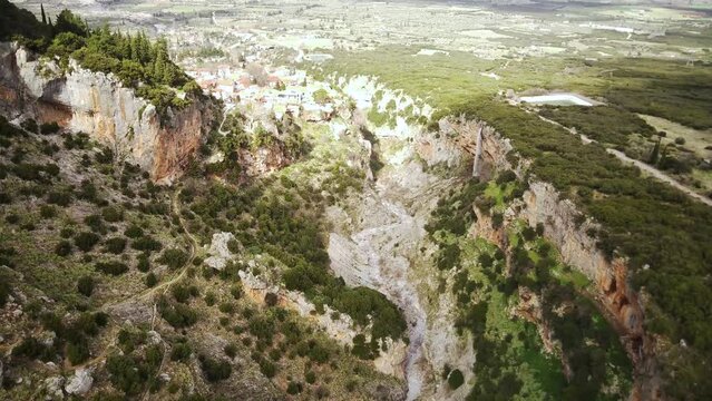 Aerial footage of Velitsa Gorge and Tithorea village on a sunny day in Amfikleia-Elateia, Greece