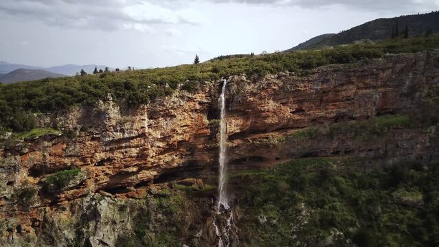 Drone footage of the Upper Tithorea Falls in Velitsa Gorge on a sunny day in Tithorea, Greece