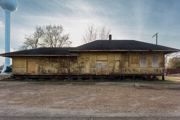 Boarded up train depot left abandoned with vines growing on walls - 718003207