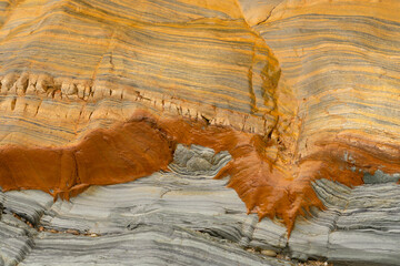 Natural rock texture of a colorful rock formations in silence beach (playa del Silencio) in...