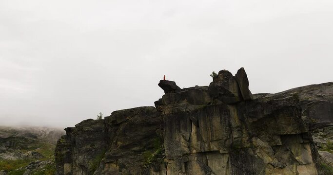 Person Standing On Top Of The Canon Rock Formation In Hellmojuvet, Norway. - aerial shot