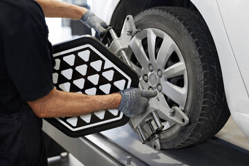 Grid sensor sets mechanic on auto. Car stand with sensors wheels for alignment camber check in...